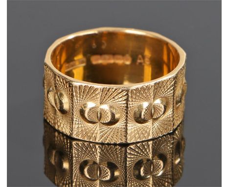 22 carat gold band, of wide proportions, decorated with angled panels with line and circular decoration, ring size S, 9 grams