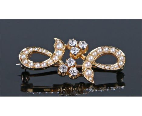 Diamond and pearl set brooch, with pearl set swags and six diamonds to the centre, 39mm diameter 