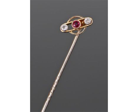 15 carat gold diamond and ruby stick pin, with a central ruby flanked by diamond to each side, the head 10mm diameter 