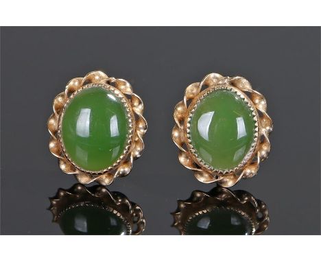 Pair of yellow metal jade set earrings, the oval jade set earrings with twist surround, 13mm high, (2)
