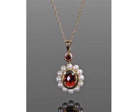9 carat gold pearl set pendant necklace, the pendant with a central red stone and pearl surround, the pendant 14mm diameter 