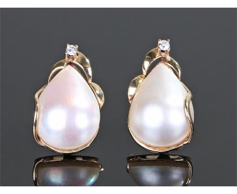 Pair of 9 carat gold pearl and diamond set earrings, the pear shaped pearl with a round cut diamond above, 23mm high, (2)