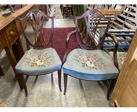A set of six Hepplewhite style mahogany shield back dining chairs with tapestry drop in seats (two with arms)