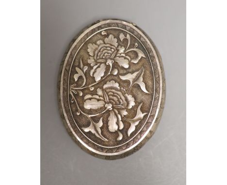 A late 19th/early 20th century Chinese white metal oval snuff box, decorate with foliage, 73mm.
