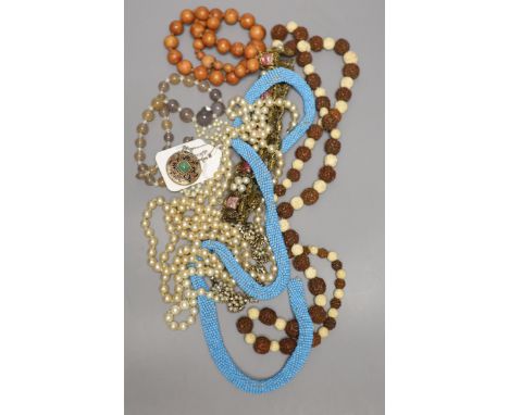 A small group of costume jewellery including necklaces and a stylish 800 standard white metal and enamel pendant.