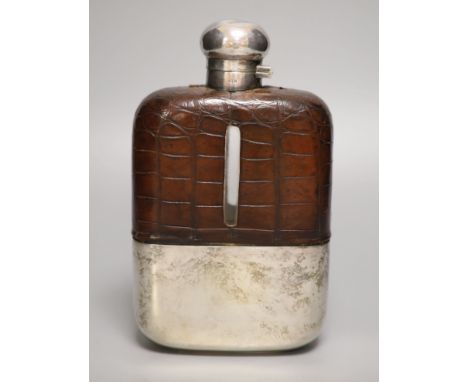 A clear cut glass and silver-plated oversized hip flask by James Dixon &amp; Sons, crocodile jacketed, with a twist-lock hing