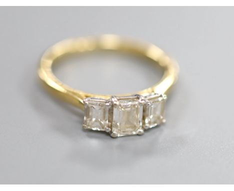 An emerald cut three-stone diamond ring, 18ct yellow and white gold setting, original box and receipt, size K, gross 3.3 gram