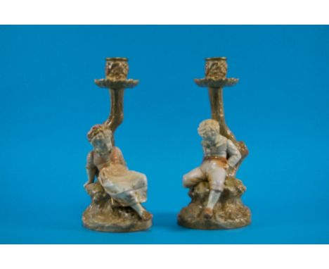 Royal Worcester Pair of Figural Polychrome and Ivory Candlesticks, In The Form of a Young Boy and Girl Resting Against a Tree