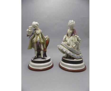 French Pair of 19thC Hand Painted Bisque Male and Female Figures in 18thC French Dress. Both looking down at a small mouse at