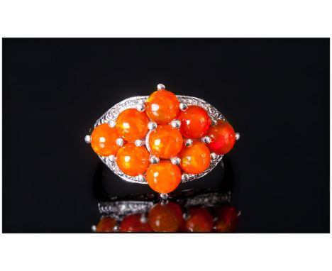 Orange Ethiopian Opal Cluster Ring, nine round cut cabochons of the unusual orange opal, which displays strong flashes of gre