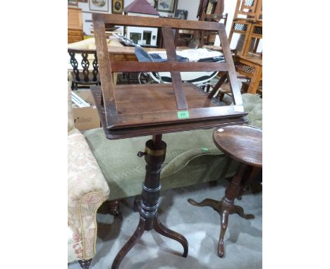 A George III mahogany reading stand, the rising top with ratchet rest and reeded edge, on turned columnar tripod support