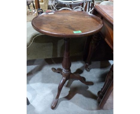 A 19th century oak lamp table on tripod support. 16 1/2' diam