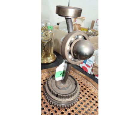 A motoring art pricket candlestick formed from gear wheels and roller bearings