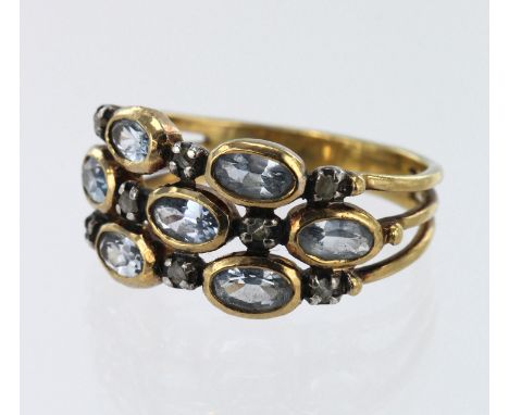 18ct yellow gold diamond and sky blue topaz scatter ring, seven oval topaz each approx. 5mm x 3mm, eight diamond spacers, hea