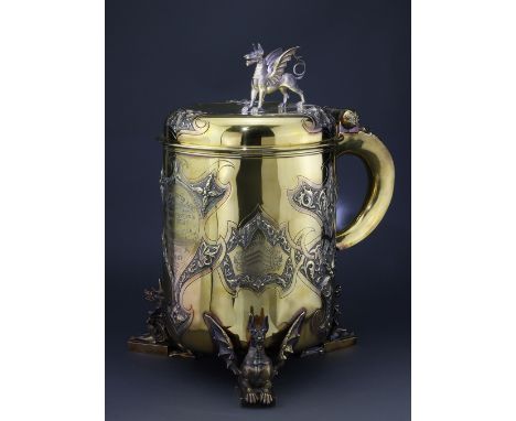 Tankard. A very large exquisite Victorian tankard trophy by Garrard, raised on three dragon feet, with dragon finial to lid, 