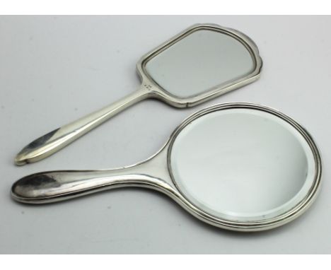 Two silver engine - turned hand mirrors, hallmarked for Birmingham, 1926 and 1956. 