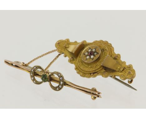 Two yellow gold (tests 9ct) antique brooches, ruby and seed pearl mourning brooch with empty panel on reverse, peridot and se