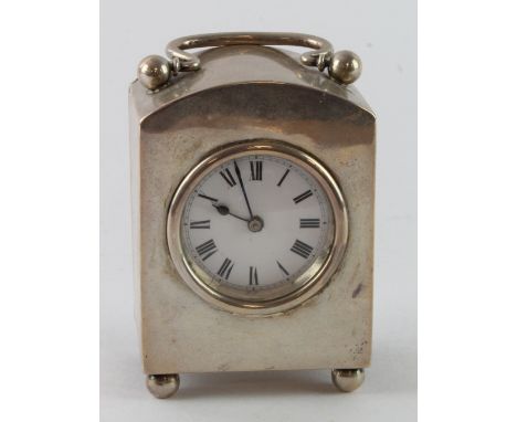 Silver carriage clock, raised on four ball feet, hallmarked 'W.N.G.N., Birmingham 1911', white enamel dial with Roman numeral