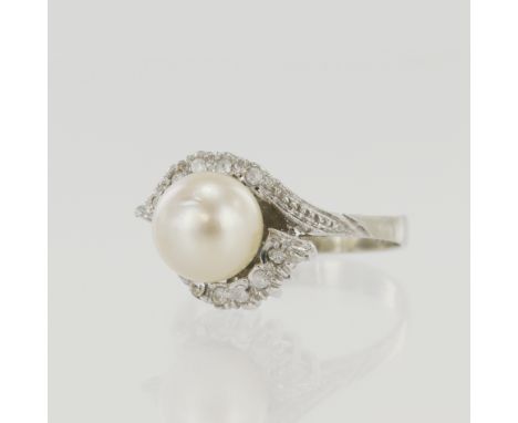 White gold (tests 18ct) pearl dress ring, one cultured pearl approx. 8.5mm, crossover shoulders set with paste stones, finger