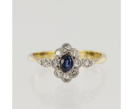 Yellow gold (tests 18ct) vintage diamond and sapphire cluster ring, one oval sapphire approx. 4mm x 2.5mm, surrounded by ten 