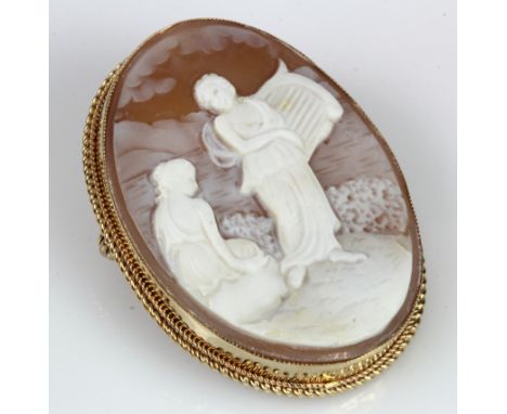 9ct yellow gold carved shell cameo brooch, depictings a maiden playing a harp, measuing 40mm x 30mm, bezel and wire work moun