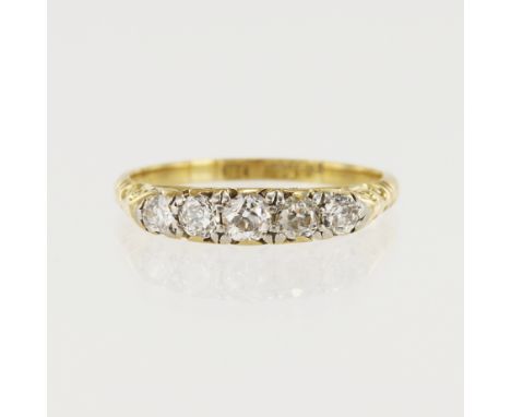 Yellow gold (tests 18ct) vintage diamond ring, five graduating old cuts TDW approx. 0.49ct, carved scroll gallery, finger siz