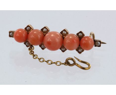 Yellow gold (tests 18ct) antique coral and seed pearl brooch, five graduating coral, principle approx. 6.5mm, ten seed pearls