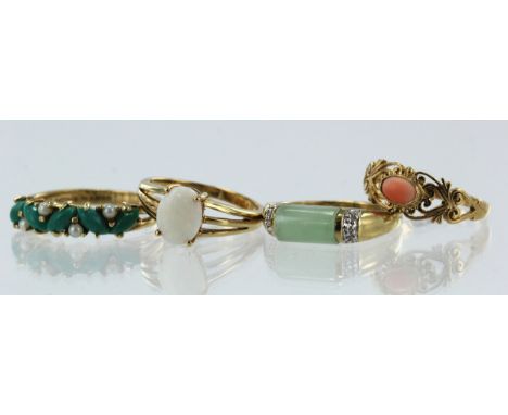 Four 9ct gold gem set dress rings, stones include diamond, opal, coral, jadeite, split pearls and green hardstone, finger siz