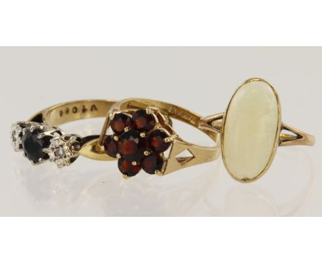 Three 9ct gold rings, stones include diamond, sapphire, opal, garnet, finger sizes J/K, L, R, total weight 6.9g.