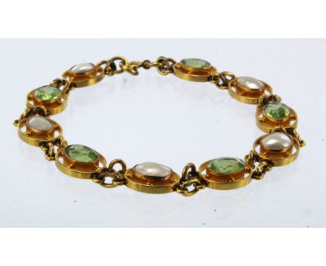 Yellow gold (tests 9ct) antique pearl and peridot linked bracelet, five oval peridots all approx. 7.5mm x 5.5mm, five split p