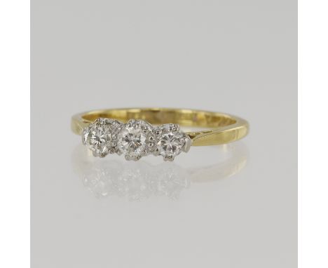 Yellow gold (tests 18ct) diamond trilogy ring, three round brilliant cuts TDW approx. 0.35ct, platinum setting, finger size J
