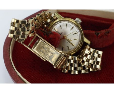 Ladies gold plated Omega Geneve manual wind wristwatch. The the silver dial with black baton markers and black outer minute t