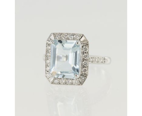 White gold (tests 18ct) diamond and aquamarine cocktail ring, one octagon step cut aquamarine approx. 3ct, surrounded by a ro