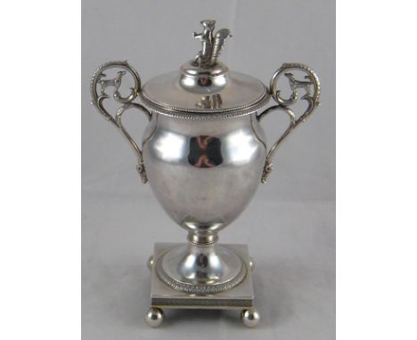 A French silver two handled cup and cover with beaded and acanthus borders, the urn with spread foot on a square base with ba