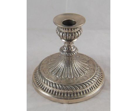 A short but impressive embossed Georgian silver candlestick on a broad base, possibly for naval use by John Green, Roberts, M