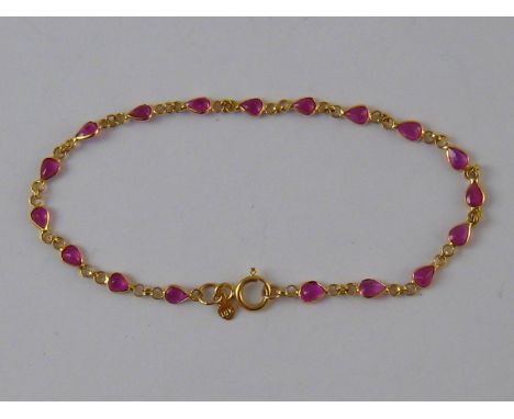 A yellow metal (tests 18 carat gold) ruby bracelet, approx 16.5cm long, 1.7 gms.
