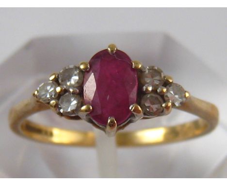 A 9 carat gold ruby and diamond ring, ruby approx 6 x 4mm, ring size M, 1.7 gms.