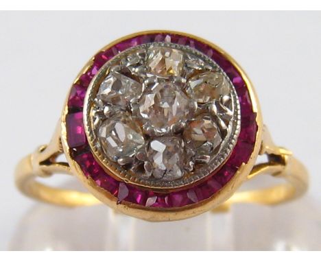 A yellow metal (tests 18 carat gold) ruby and old cut diamond ring, head approx 11.5mm diameter, ring size M, 2.7 gms.
