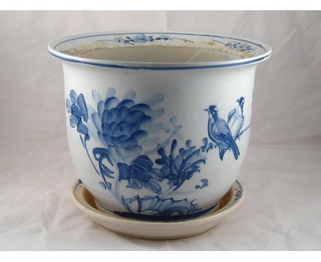 A Chinese ceramic planter and underplate, the white body freely hand painted in blue with birds on prunus. ( crack to base.) 