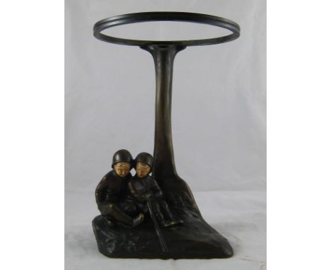 A bronze base for a Galle lamp after Peter Tereszczuk (1875-1963) formed as two young hikers with ivory faces resting below a