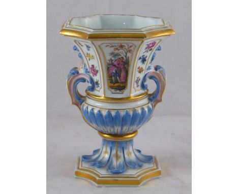 A ceramic two handled urn shaped vase of rectangular section with incurved corners on a conforming stiff acanthus base. Hand 