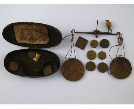 A pair of early 19th. century scales with weights in original oval metal case, maker's label inside lid. 
