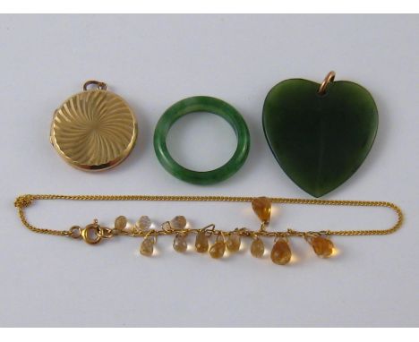 A mixed lot comprising a citrine bracelet (clasp marked 9k), a nephrite heart pendant, a locket and a jade ring.
