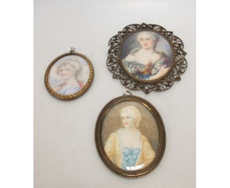 Three oval portrait miniatures of Ladies in metal oval frames, one signed 'Loty' another 'V. May.' (3)  