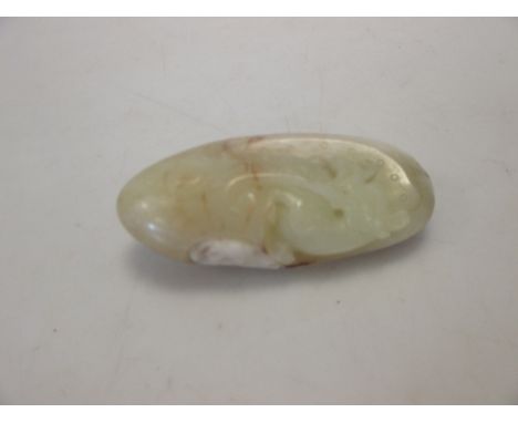 A 19th century Chinese carved and polished russet jade pebble  