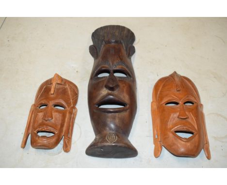 A trio of vintage tribal-style wooden face masks, 49cm tallest (3).  