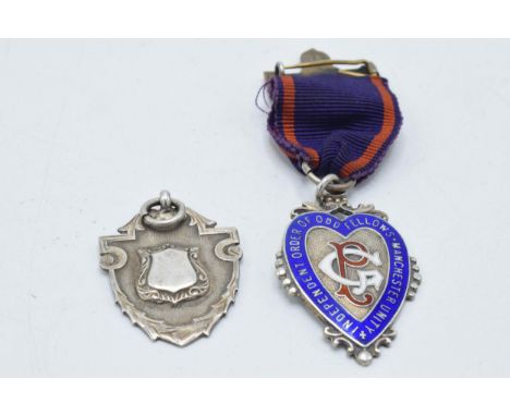 A silver enamelled Oddfellows of Manchester fob together with a silver shield fob (2).  