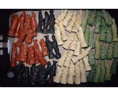 A pair of resin chess pieces set of oriental themes in the manner of jade and other precious materials (2 sets).  Odd pieces 