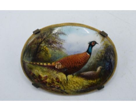 Painted oval porcelain brooch depicting pheasants in the woodland, signed R Hague, possibly for Minton, in metal fitting, 42m
