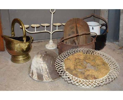 A collection of metalware to include large cast iron cooking pots, an enamel jug, vintage helmet, brass coal bucket and other